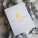 White gift box with the Houses of Parliament logo in gold coloured print