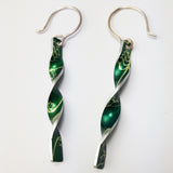 Green aluminium twist earrings with a lily of the valley flower print on both sides with silvery coloured edges and silver hook wires.