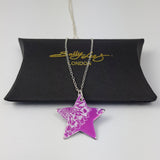 Bright pink star pendant hand crafted from anodised aluminium and printed with a silvery coloured print of an aster flower displayed on a silver chain on a black gift box with the Sally Lees Logo in goil foil