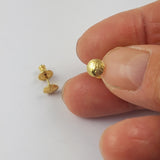 Small stud part of gold coated sterling silver stud earrings with a pattern of roses etched into it