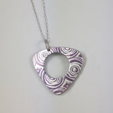 Women's suffrage triangular shaped reversible pendant printed with purple and silver pattern 