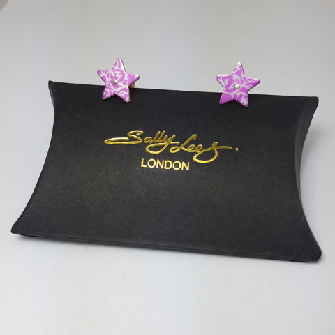 Aluminium pink star studs with abstract roses pattern in a silvery colour.
