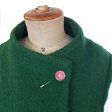 New Dawn red pin displayed on green coat