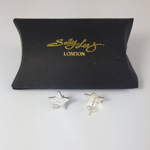 Sterling silver star stud earrings by Sally Lees photographed with a black pillow shaped gift box